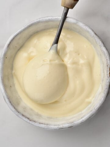 homemade Mayonaise in a small cup with a spoon square