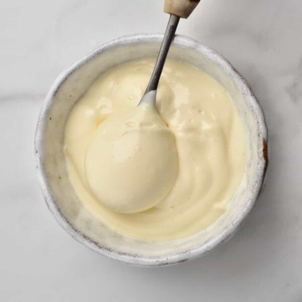 homemade Mayonaise in a small cup with a spoon square