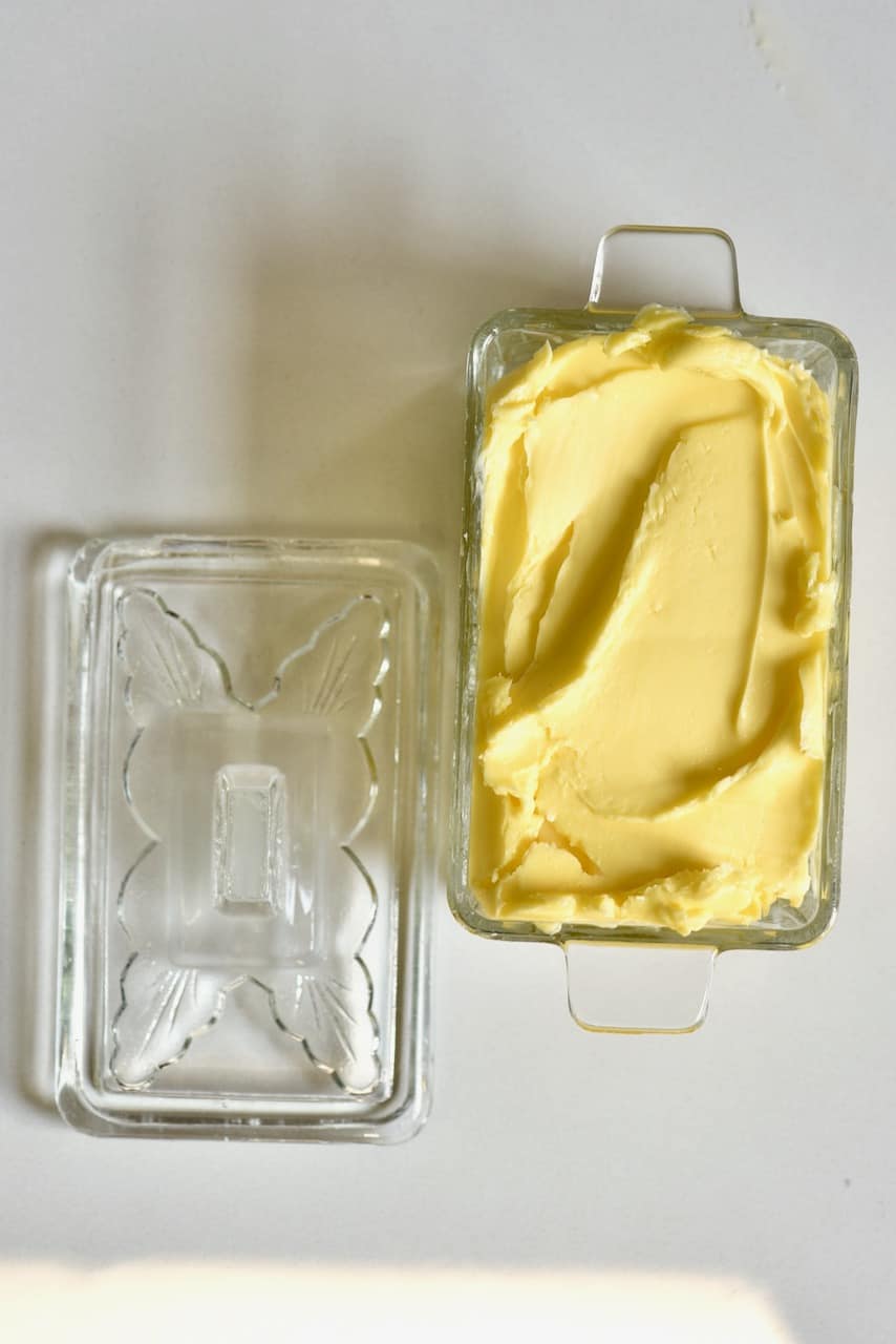 homemade butter in a clear glass container with a lid on the side
