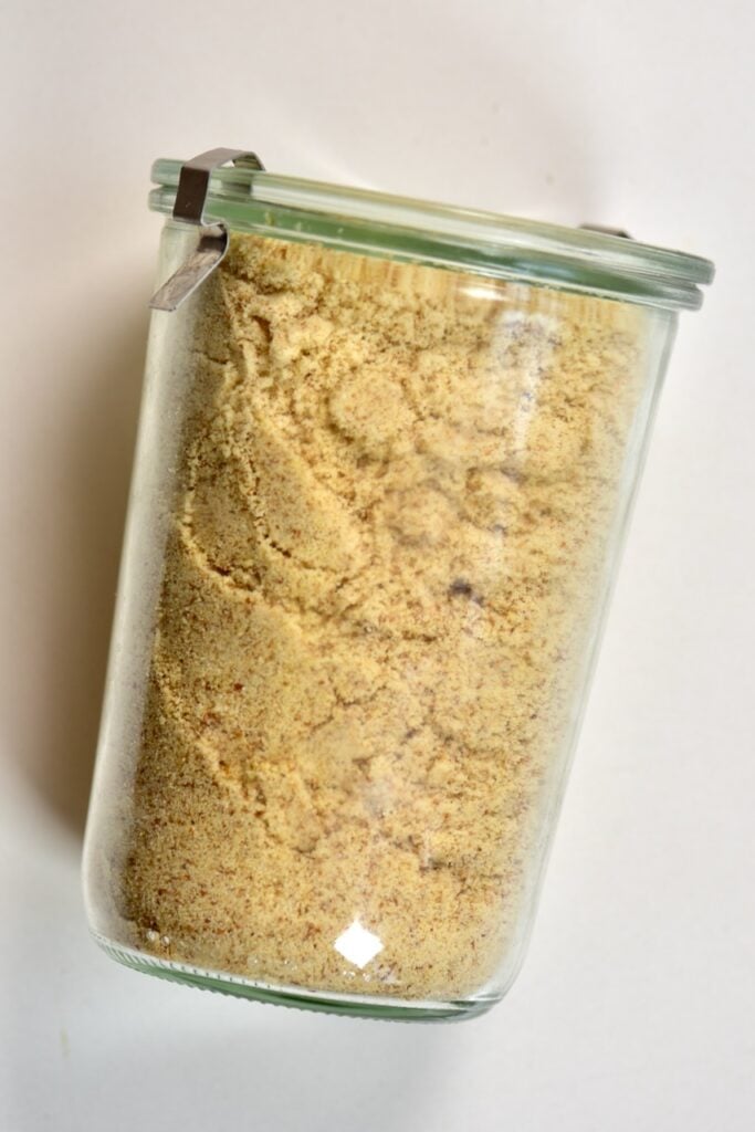 laid closed glass jar of almond meal