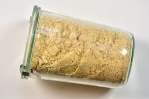 laid closed glass jar of almond meal