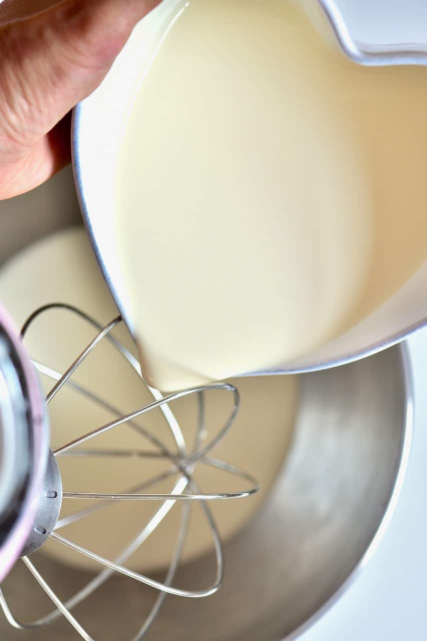 pouring double cream into a stand up mixer