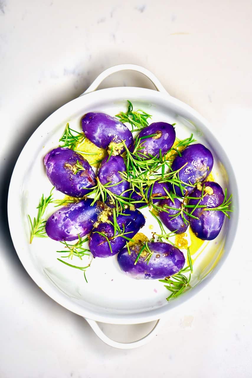 purple potatoes herbs and dressing before roasting