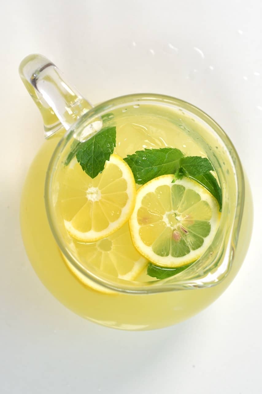 top view lemonade jug with lemon and mint slices