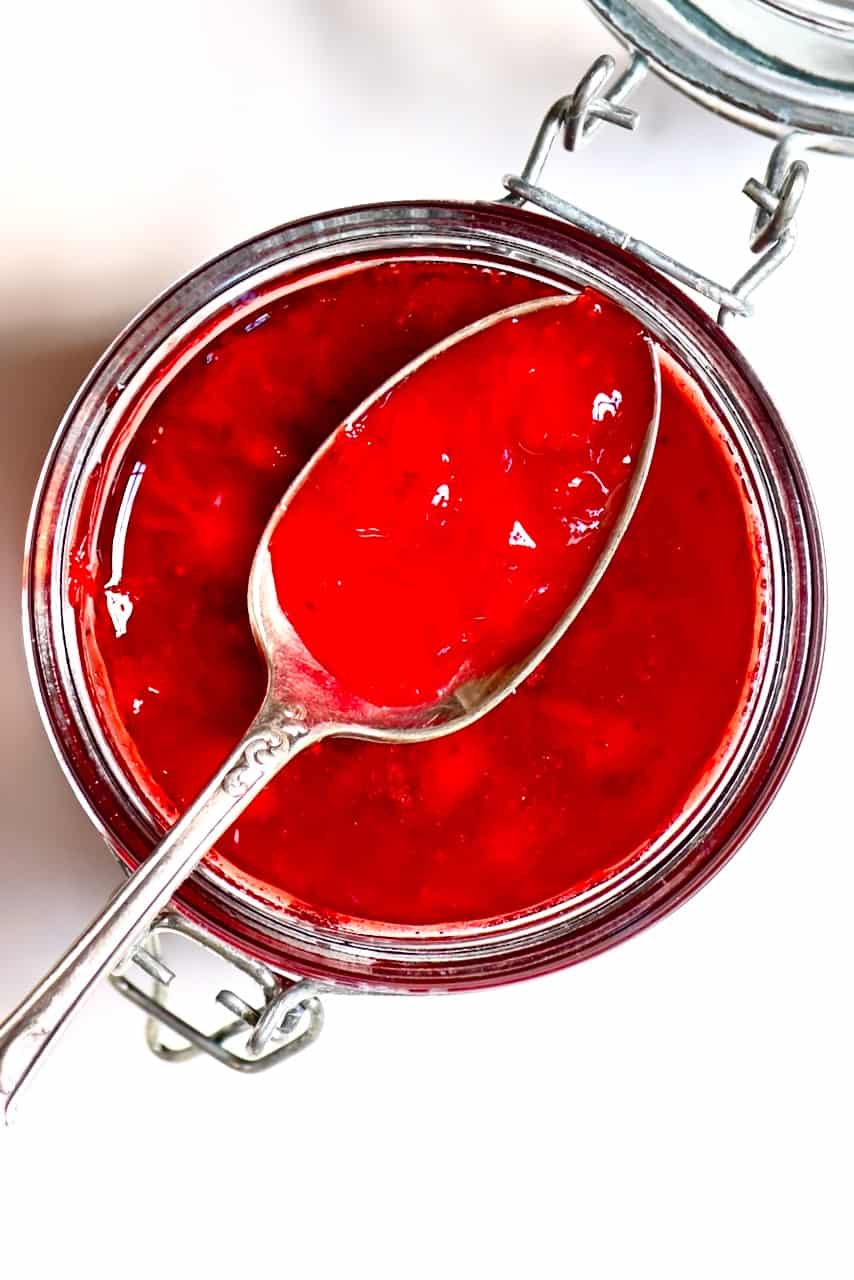 A spoon full of Strawberry Jam