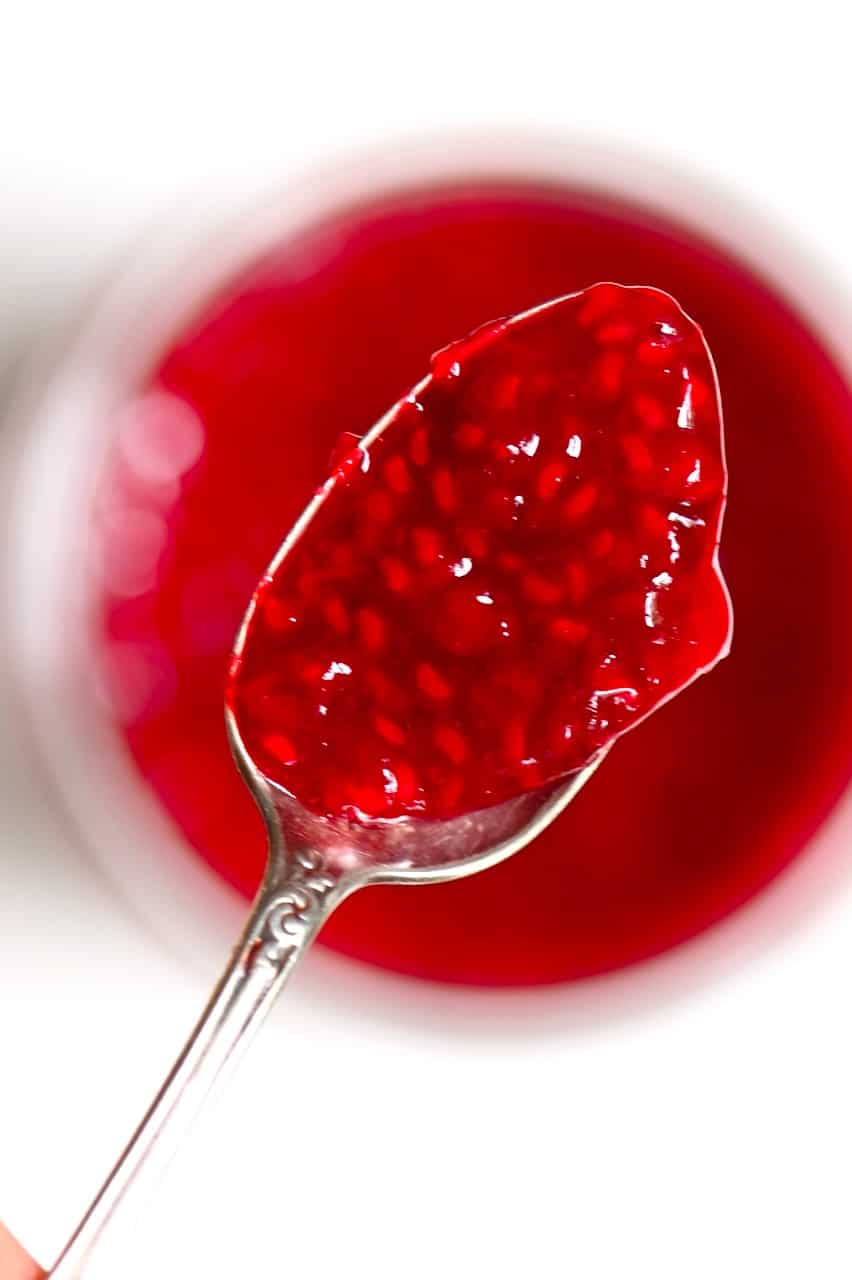 A spoon full of homemade Raspberry Jam