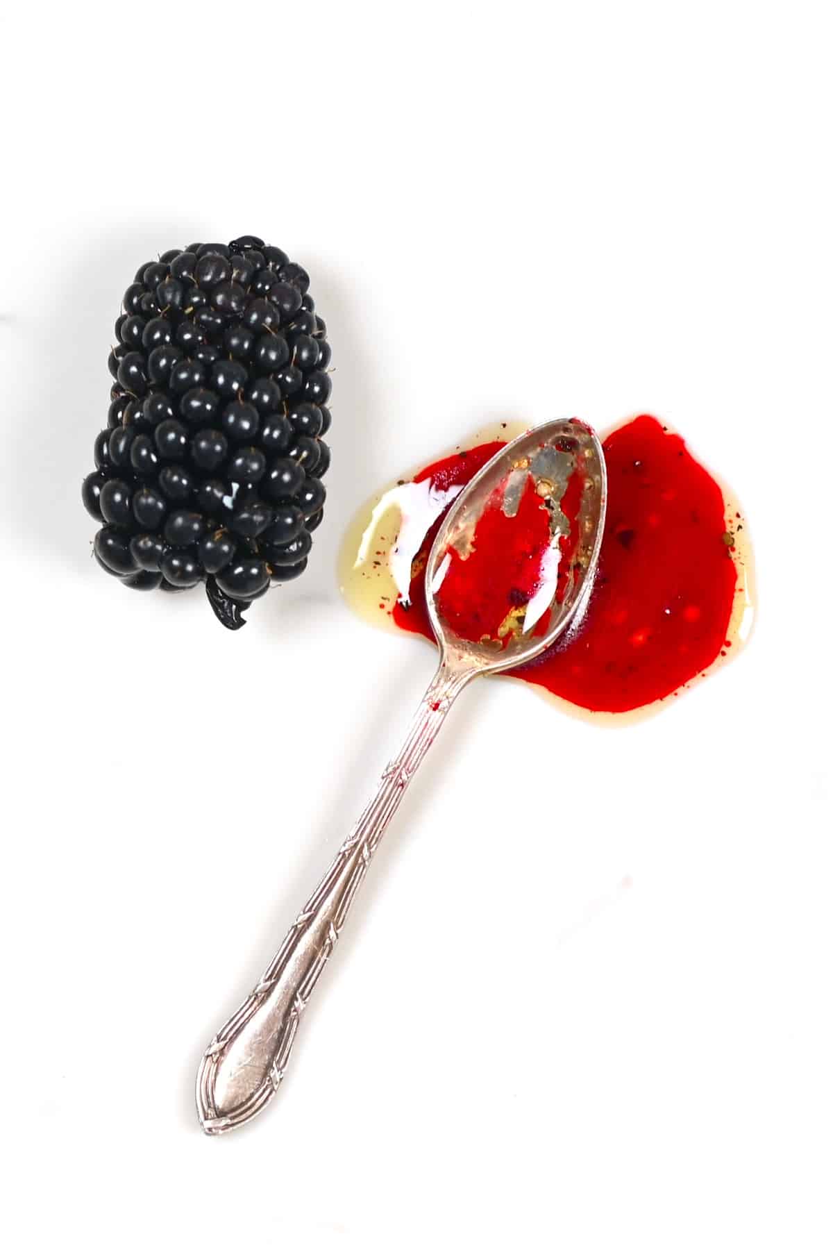 A spoonful of blackberry salad dressing and a blackberry