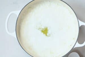 Curdling goat milk in white pot