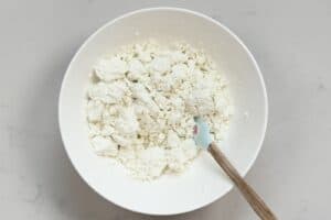 Goat cheese in a bowl with a spatula