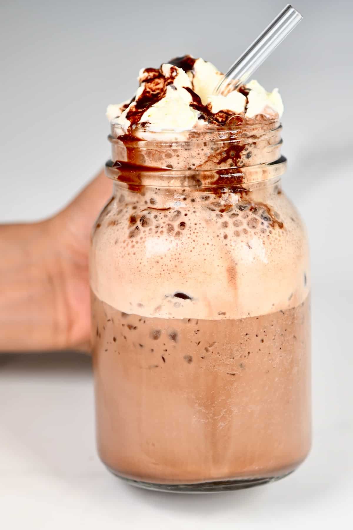 Mocha Frappuccino topped with whipped cream and chocolate syrup