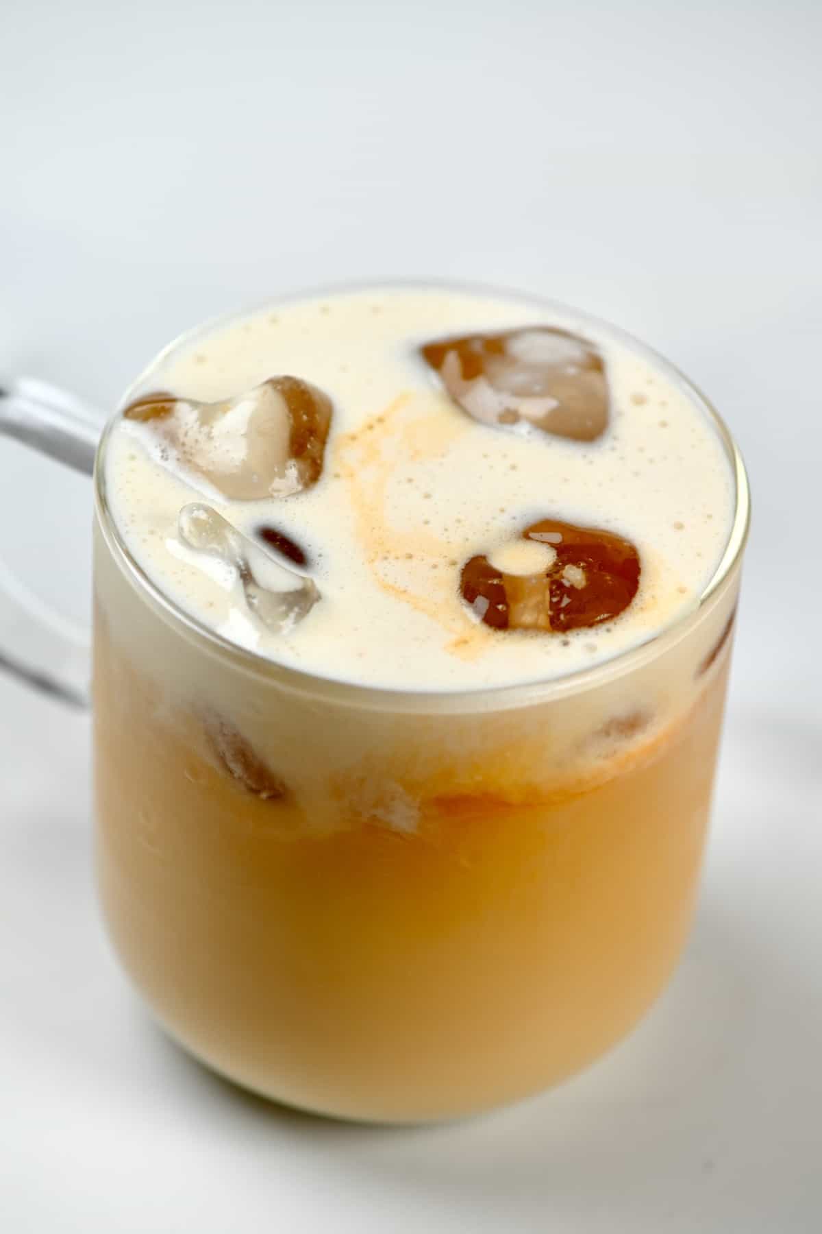 Iced latte with cream in a glass