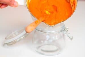 Pouring Turmeric Paste into a glass jar