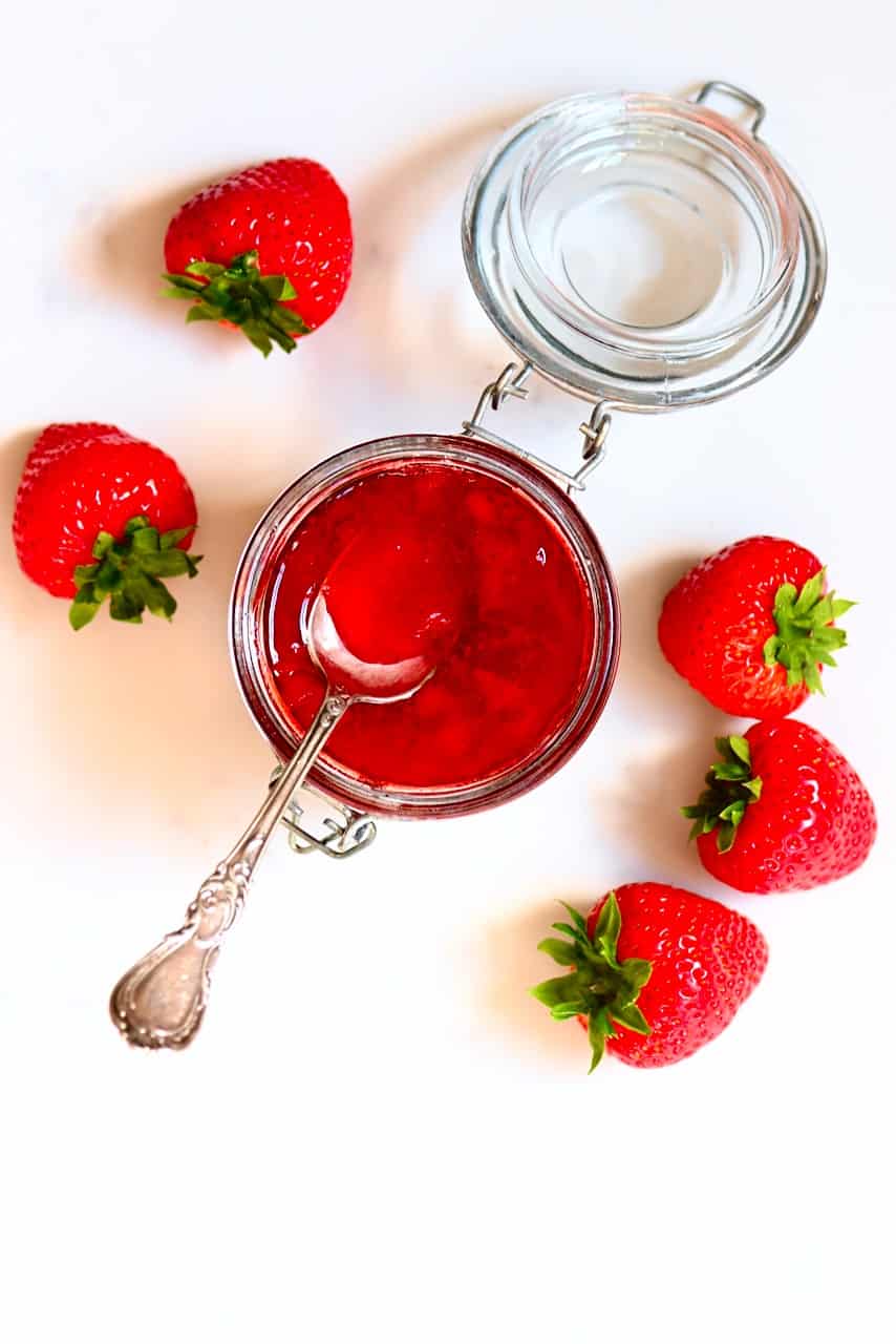 Strawberry Jam in a jar with strawberries on the side