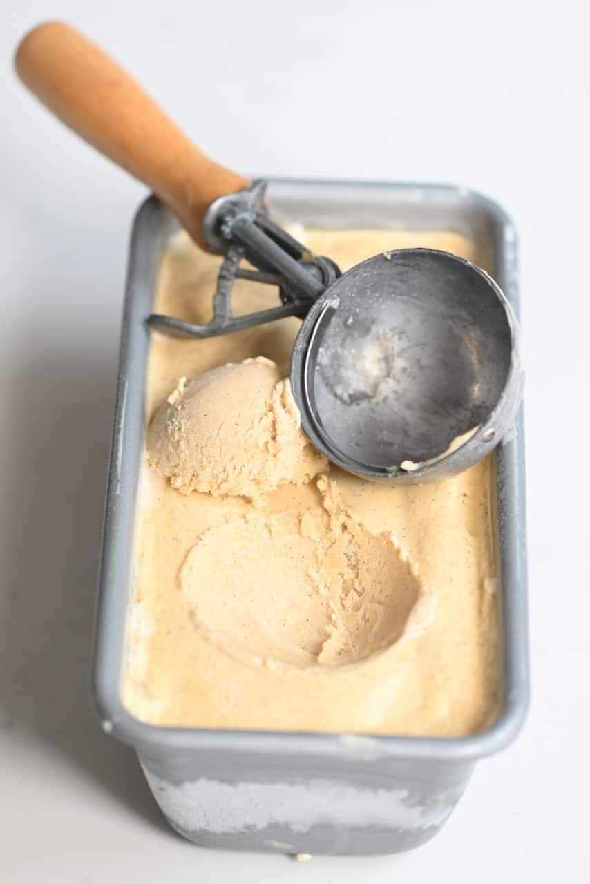 caramel ice cream tub with a scoop