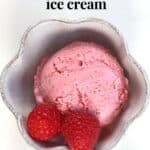 Raspberry ice cream scoop in a white flower shape cup