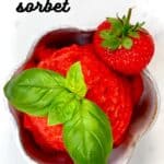 Strawberry Sorbet in a bowl with a strawberry and basil