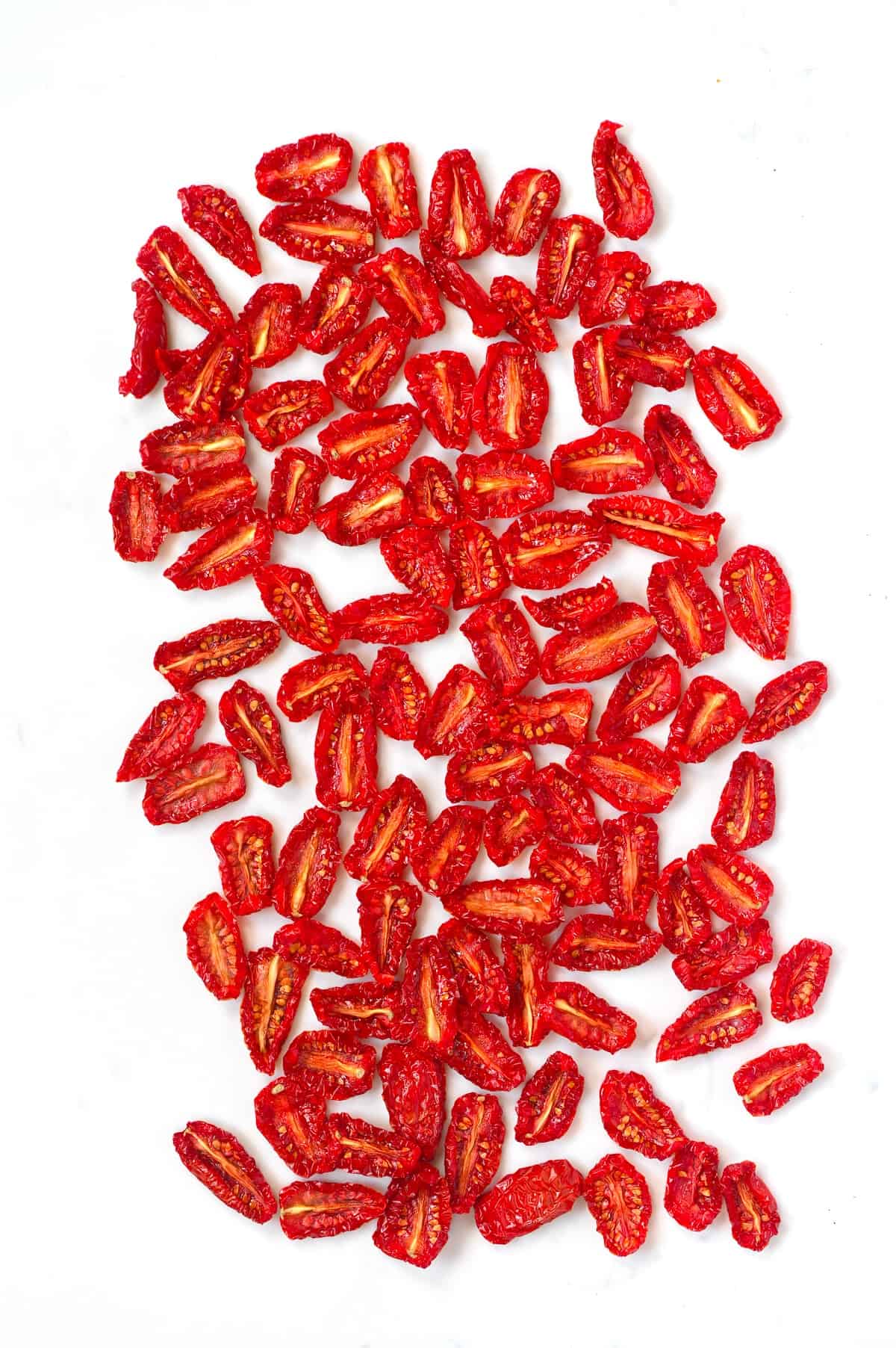 Sun dried tomatoes on a white surface