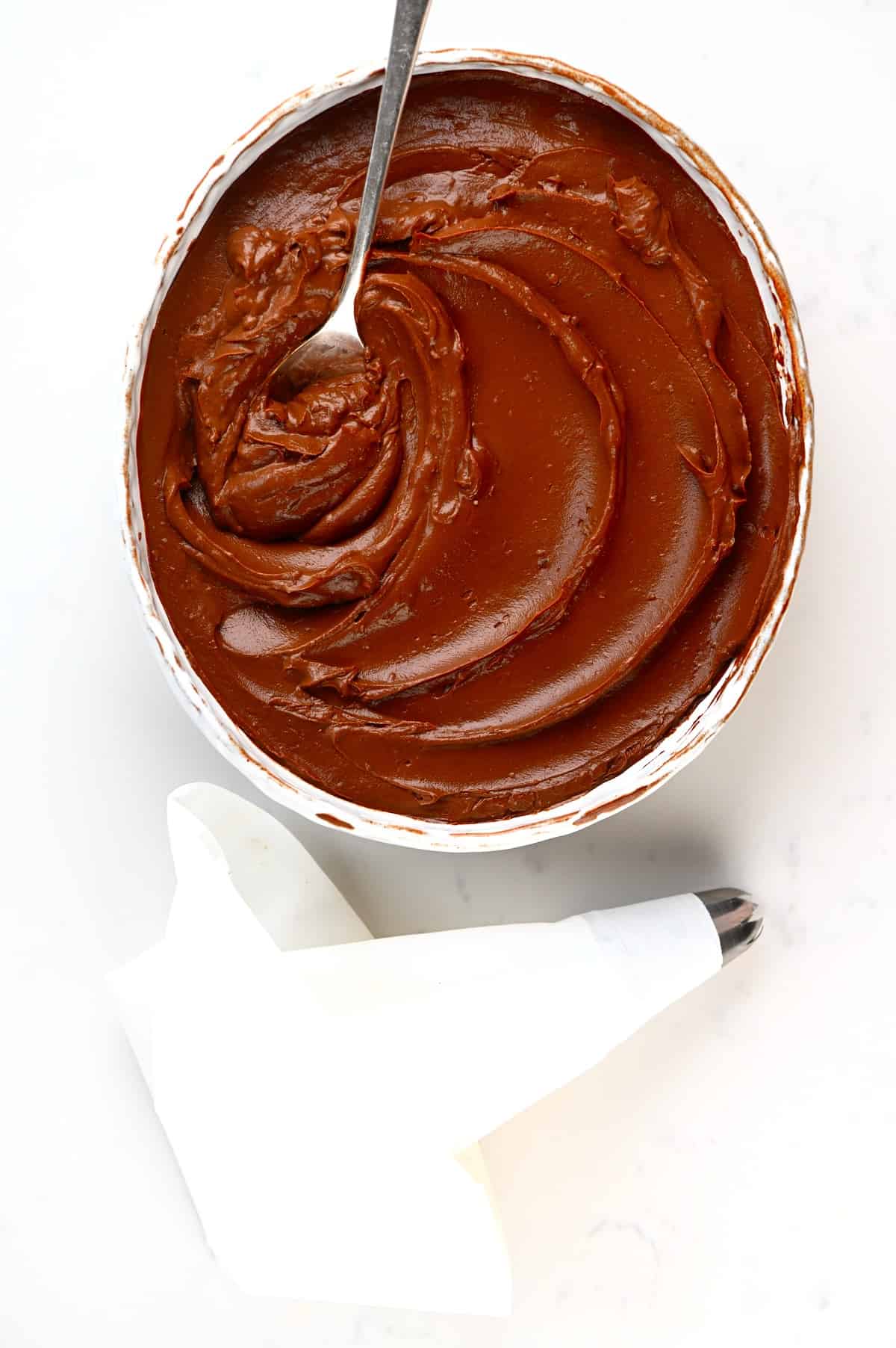 A bowl with Chocolate Pastry Cream and a piping bag