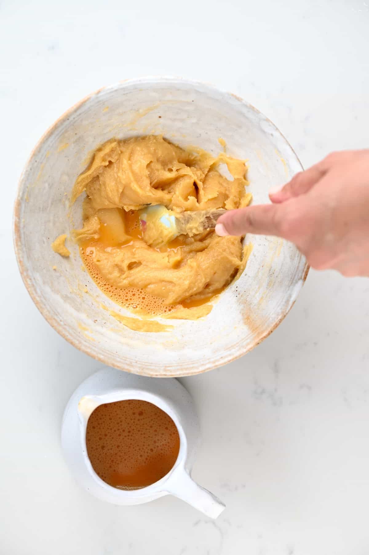 Mixing eggs into choux pastry dough
