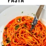 Roasted Red Pepper Pasta with a fork in a white plate