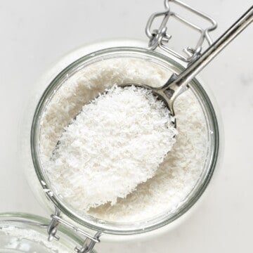 Shredded Coconut in a spoon over a jar
