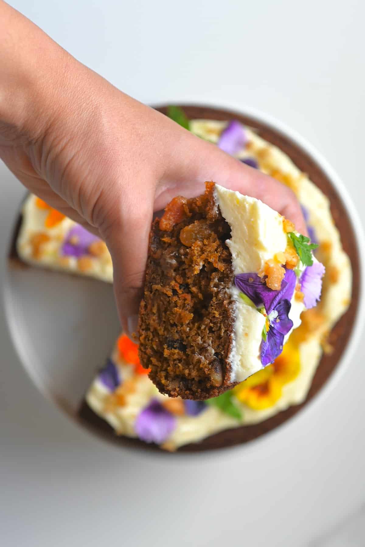 A close up of a slice of carrot cake with frosting