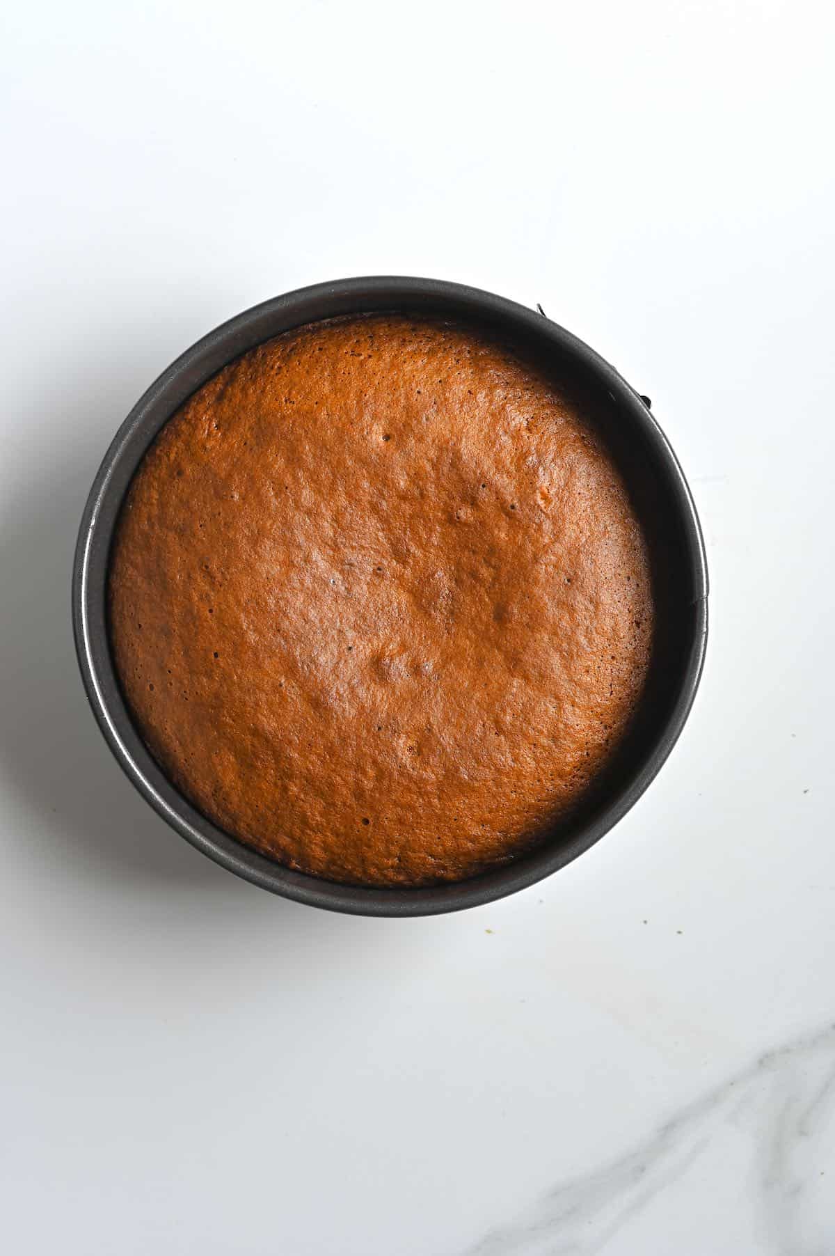 Baked carrot cake in a round baking tin