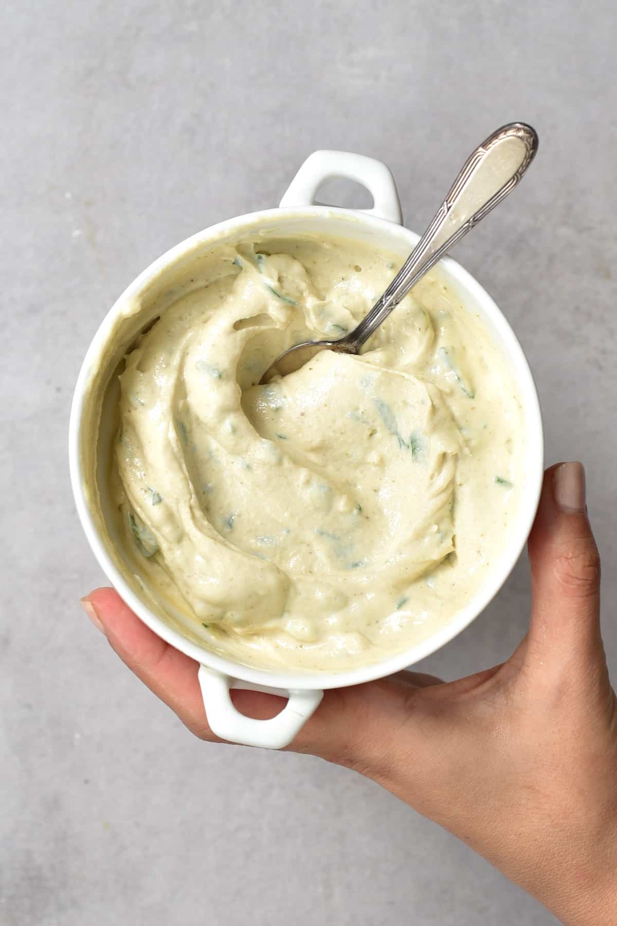 Tahini sauce in a bowl with a spoon