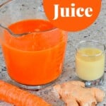 A measuring cup with carrot juice and a small cup with ginger juice