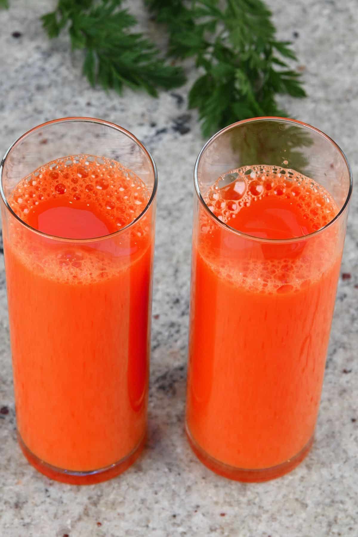 Two glasses with carrot juice
