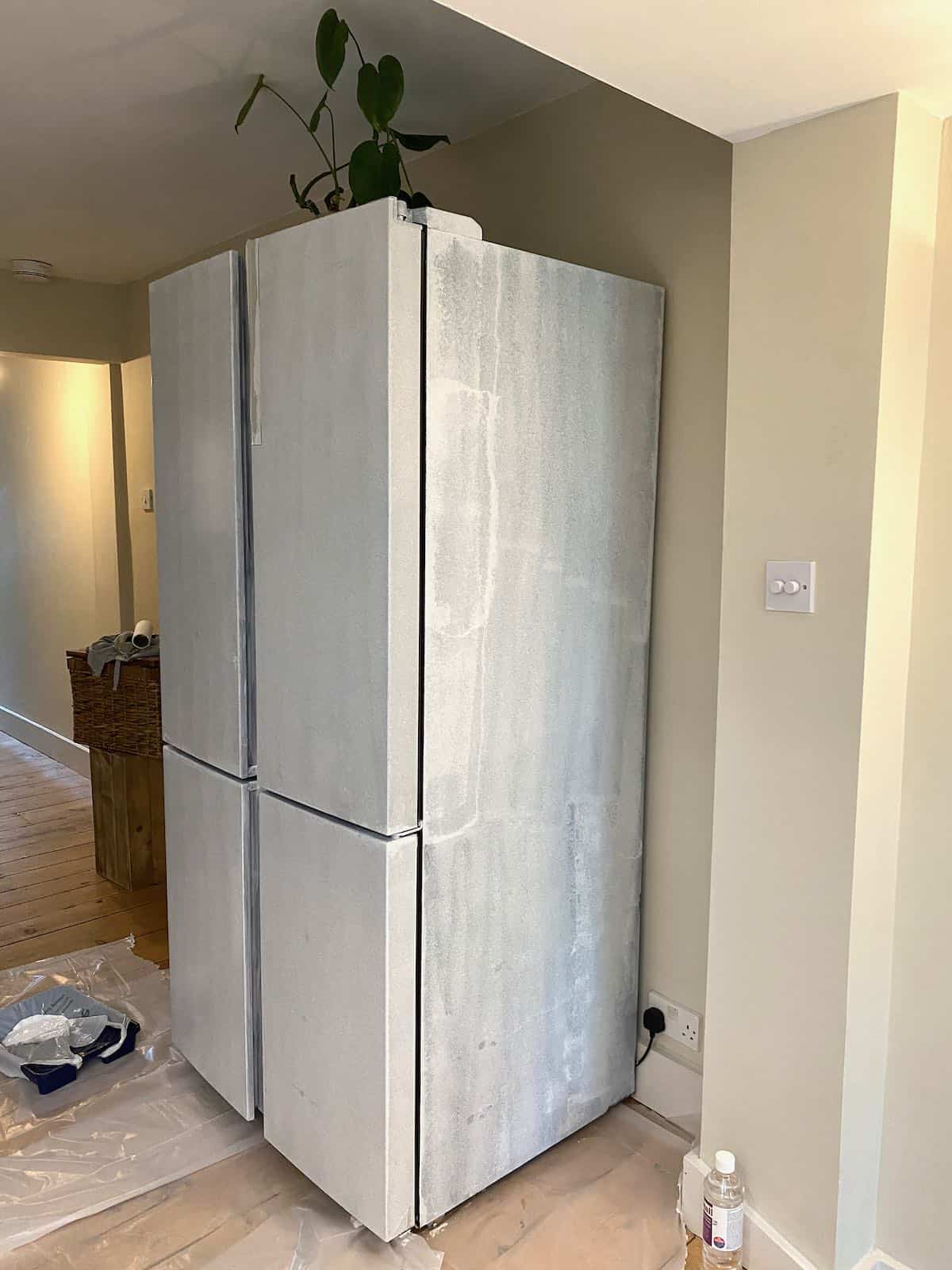 The side of a fridge freezer painted in primer