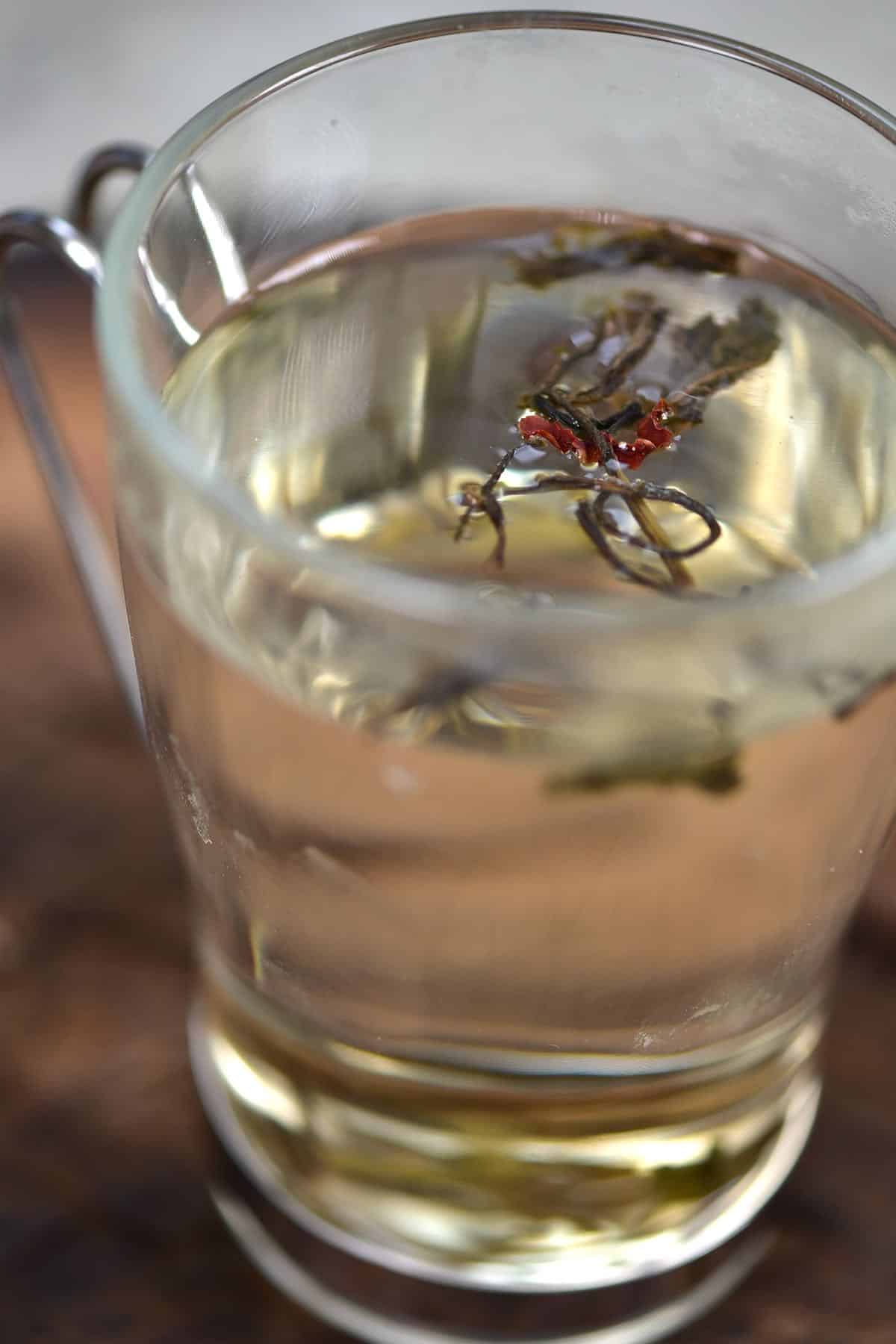 Steeping tea in a tall glass