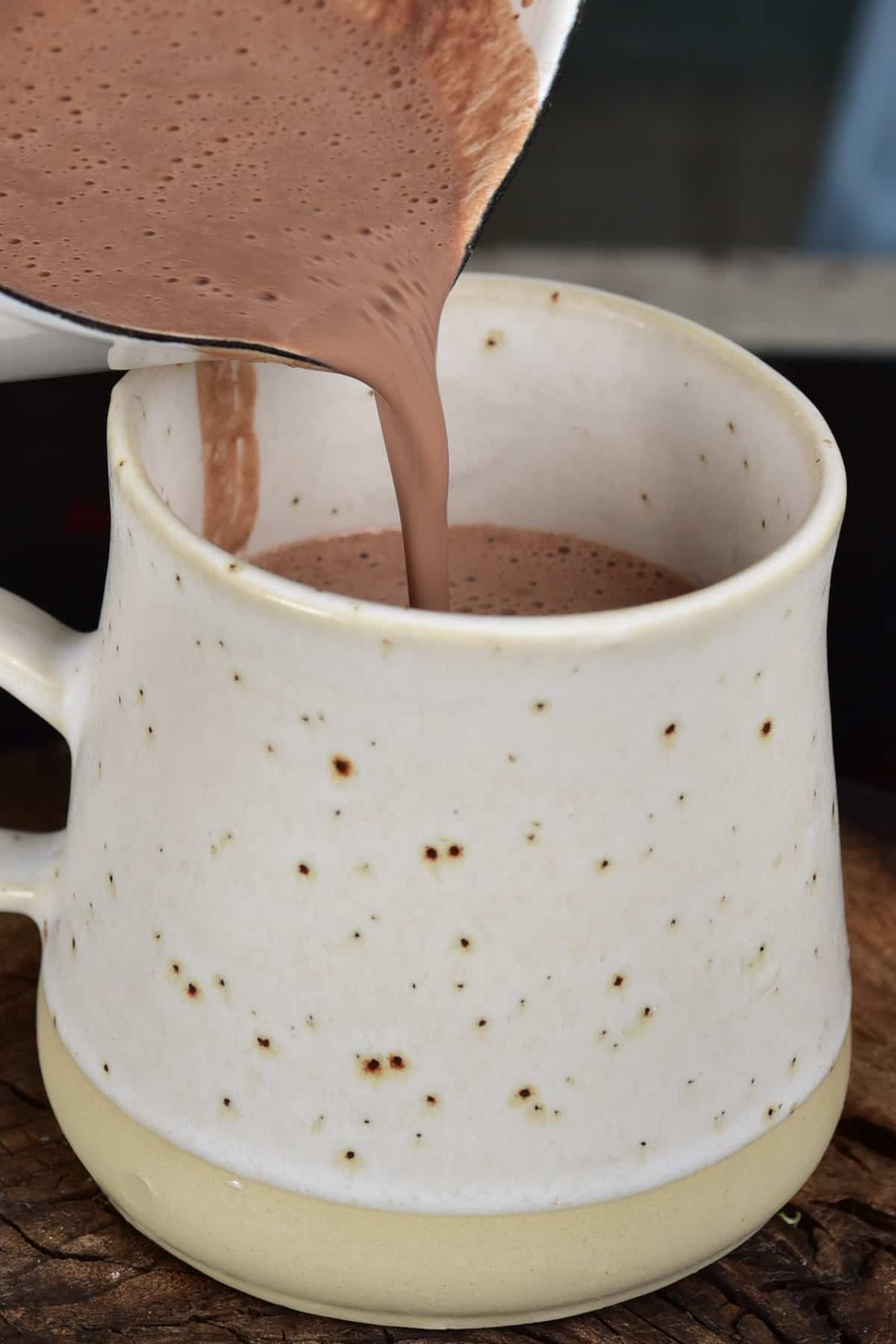 Pouring hot chocolate in a cup