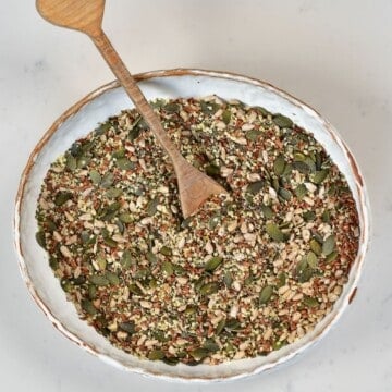 Omega seed mix in a bowl with a wooden spoon