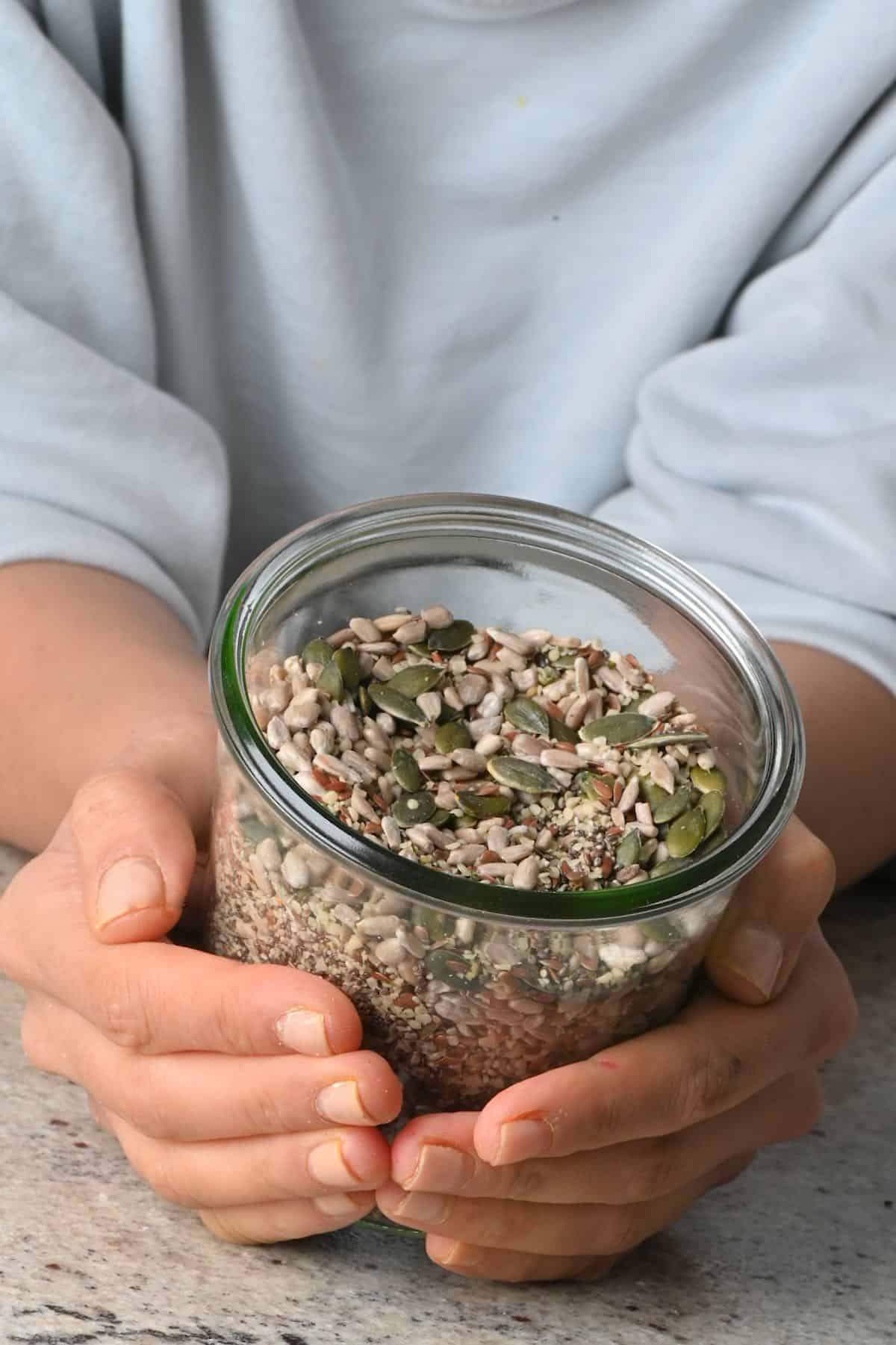 Holding a jar with omega seed mix