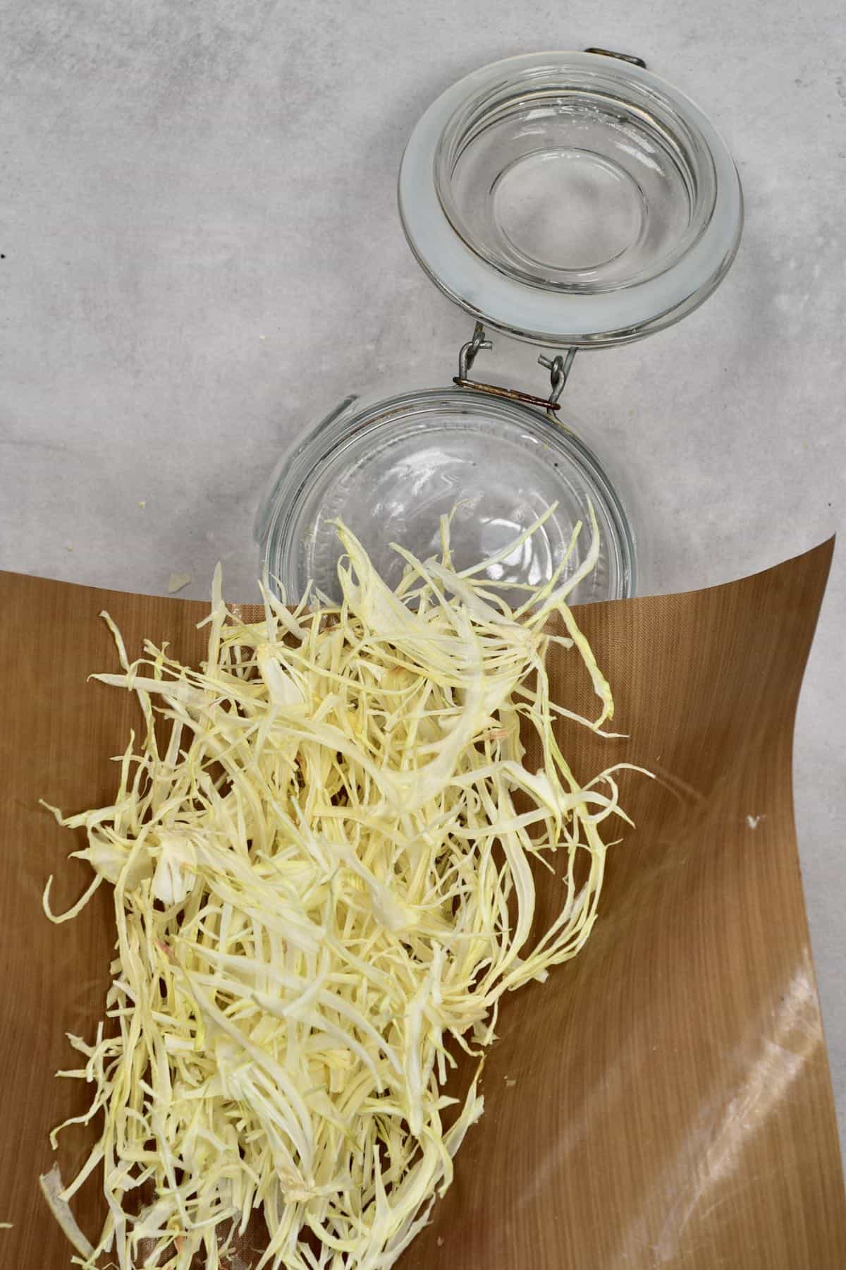 Moving dried onion flakes into a jar