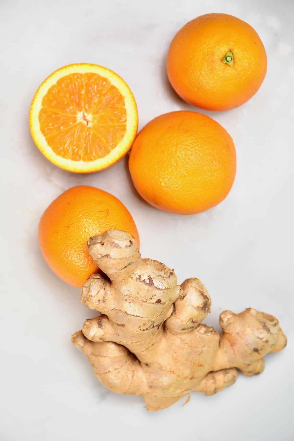 Oranges and ginger on a flat surface