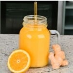 A mason jar with Orange Ginger Juice