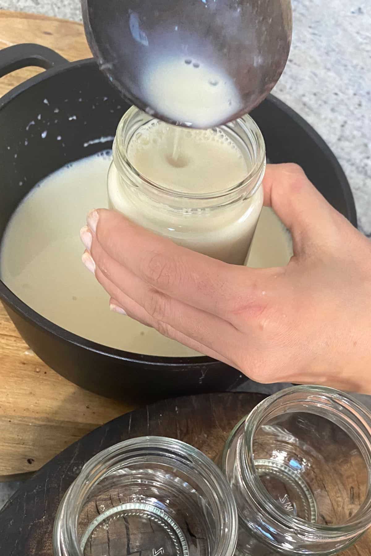 Filling up little jars with soy milk
