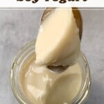 A spoonful of soy yogurt over a glass jar