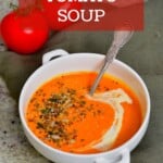 A bowl of tomato soup topped with seeds