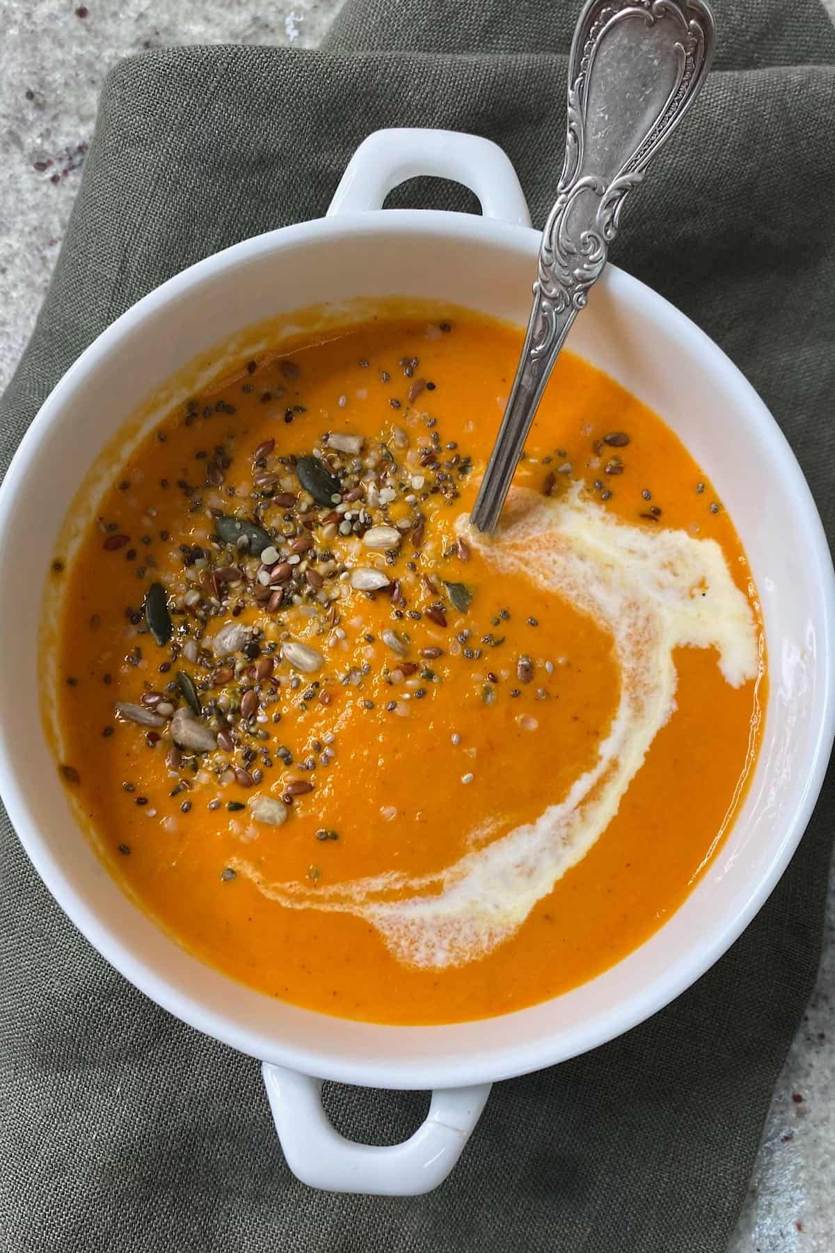 Tomato soup in a bowl topped with seeds