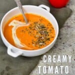 A bowl of tomato soup topped with seeds