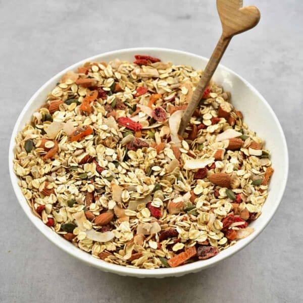 Homemade muesli in a bowl with a wooden spoon