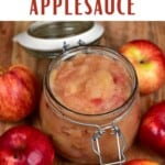 Applesauce in a jar with a few apples around it