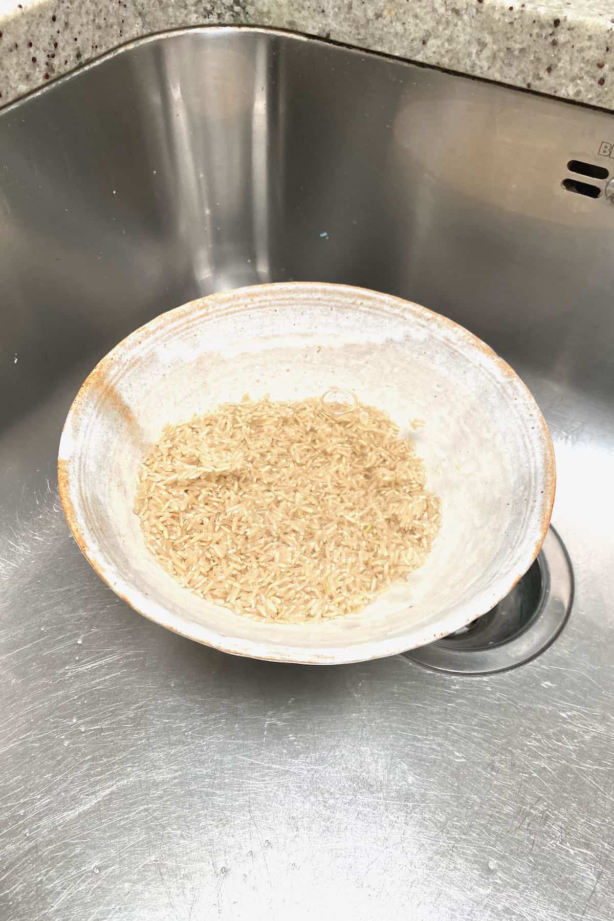 Rinsing rice in a bowl in the sink