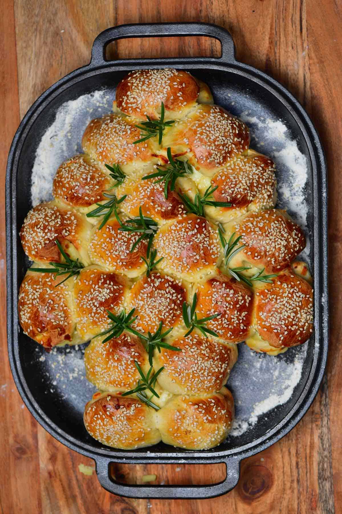 Christmas tree shaped cheese buns topped with rosemary