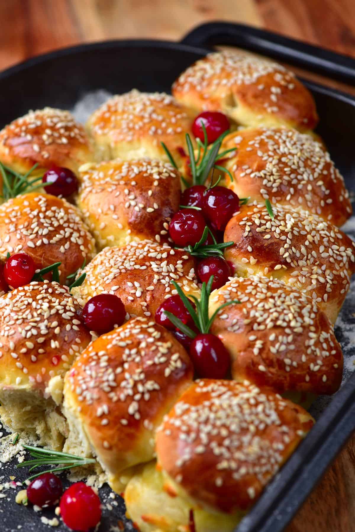 Cheese buns topped with rosemary and cranberries