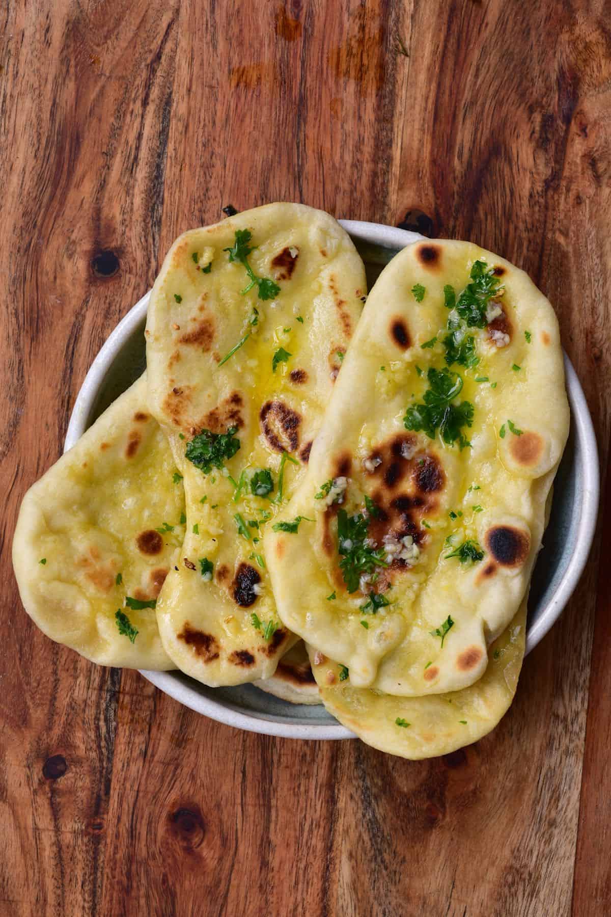 A few naan breads in a bowl