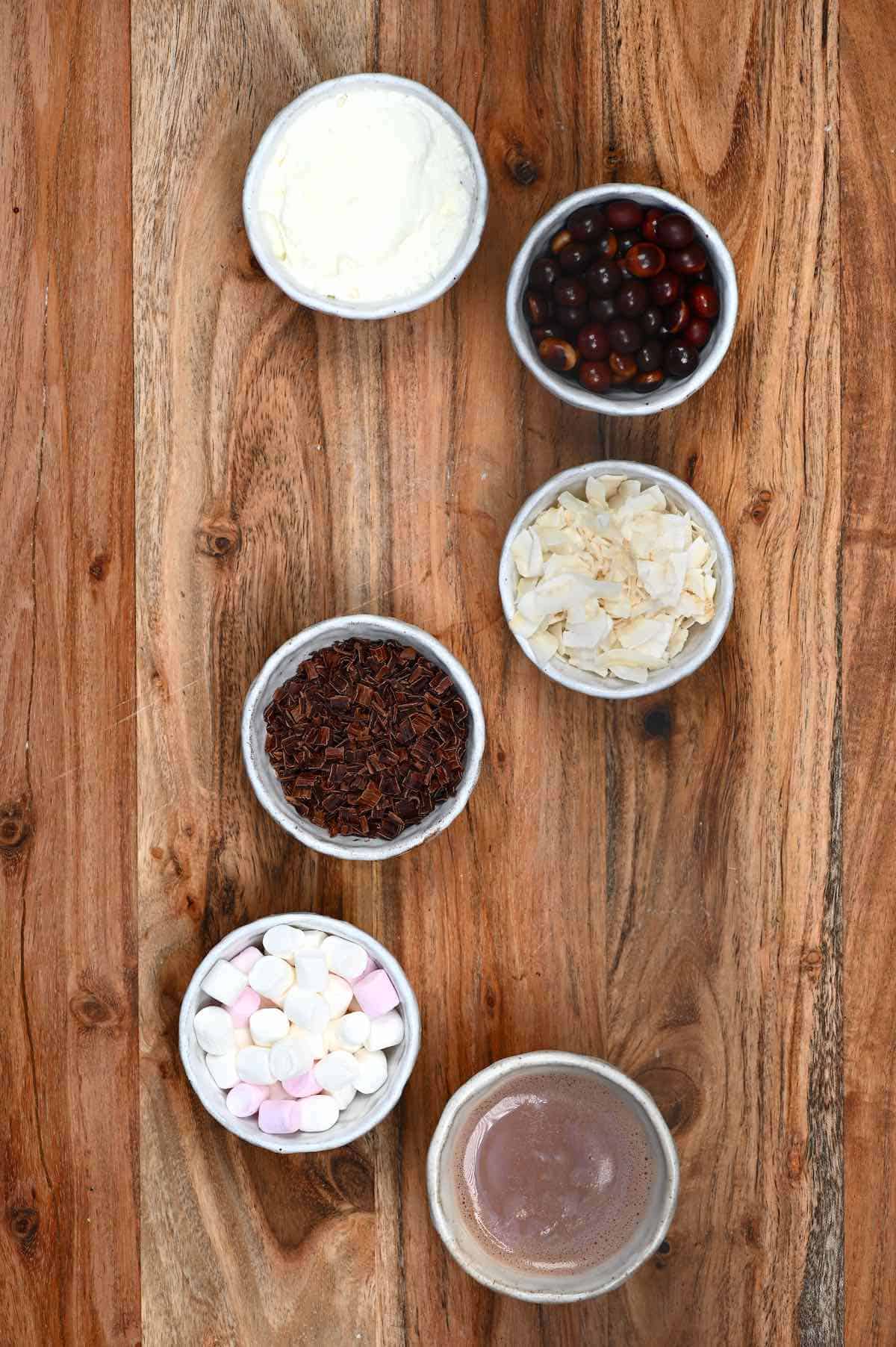 Different toppings for hot chocolate placed in small bowls